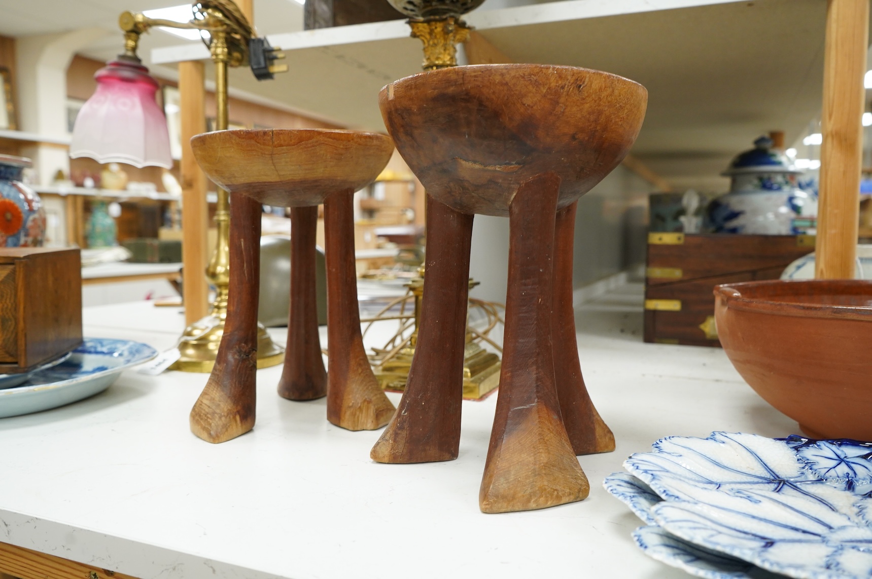 Two African tribal carved hardwood three-legged stools, tallest 28.5cm